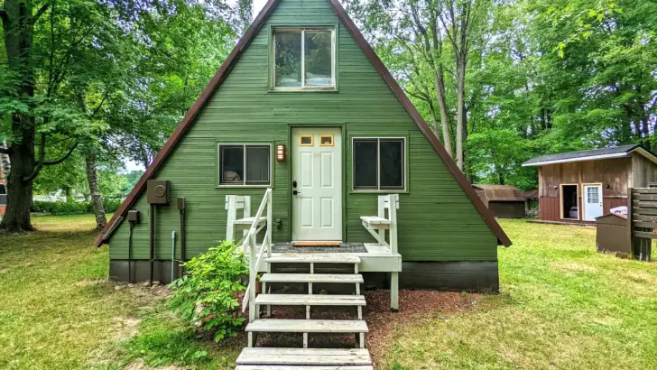 The Small Green A-Frame Cabin Has A Magical Design and a Beautiful Interior