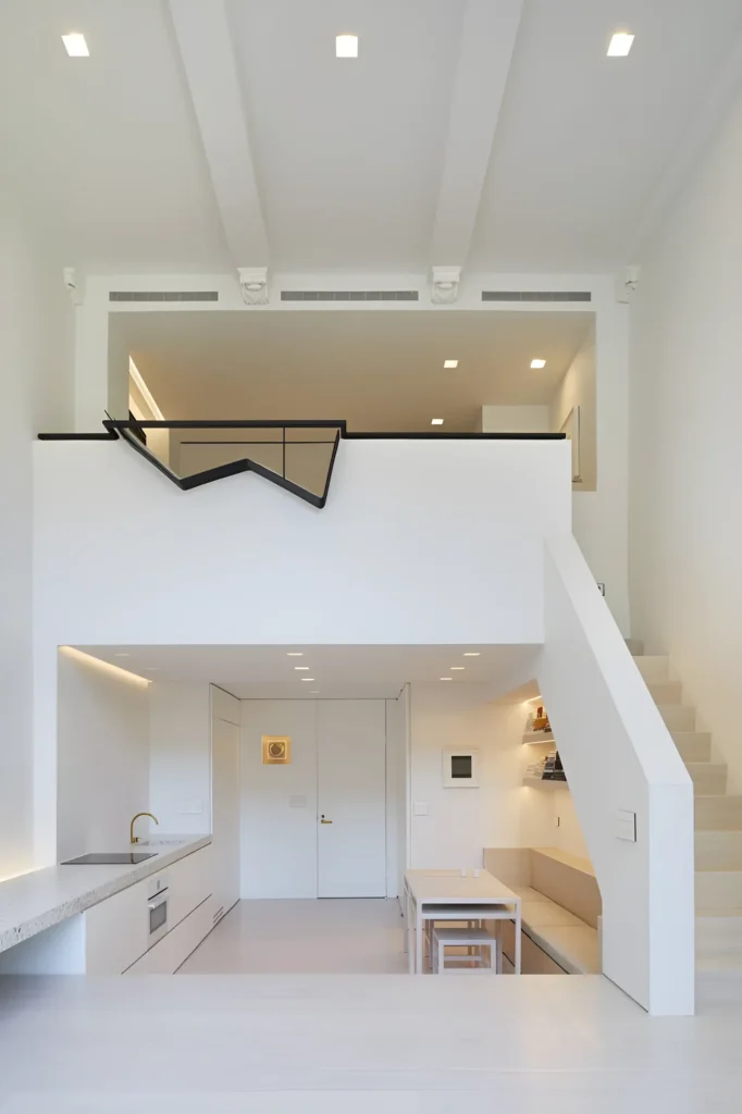 Ultra-modern white loft with sculptural railing, exposed beams, and integrated dining areas.