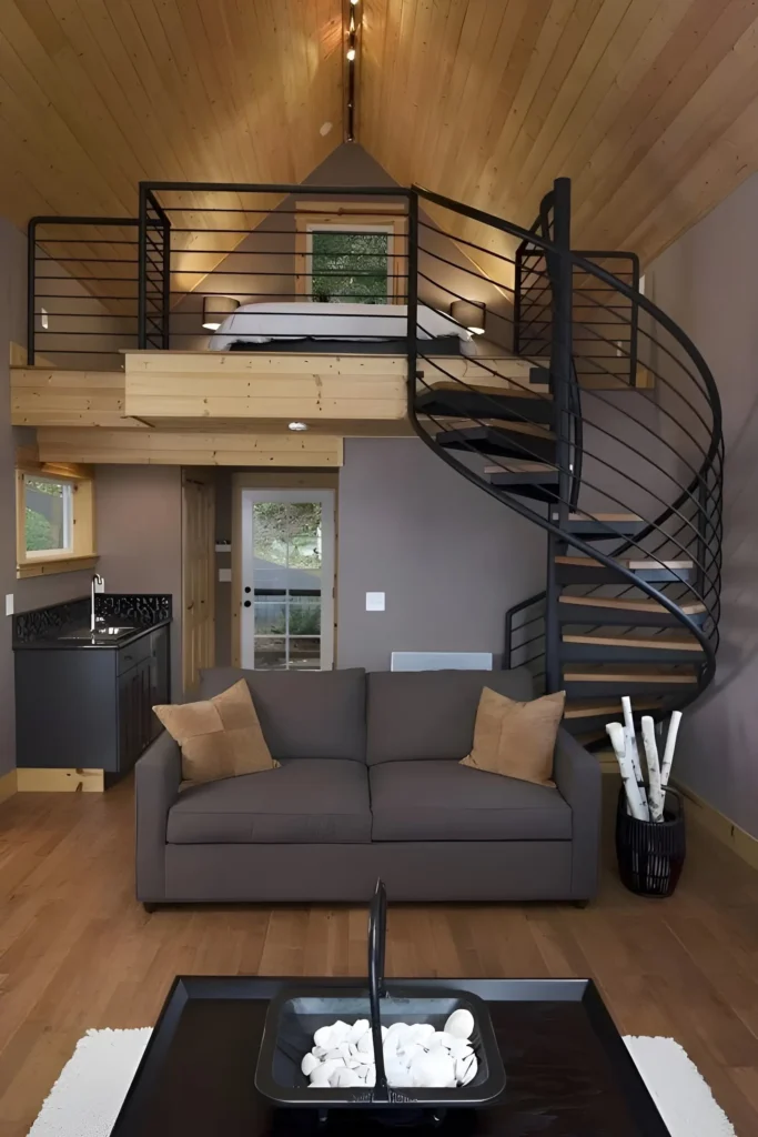 Rustic loft with wood-paneled ceiling, spiral staircase, and earthy-toned decor.