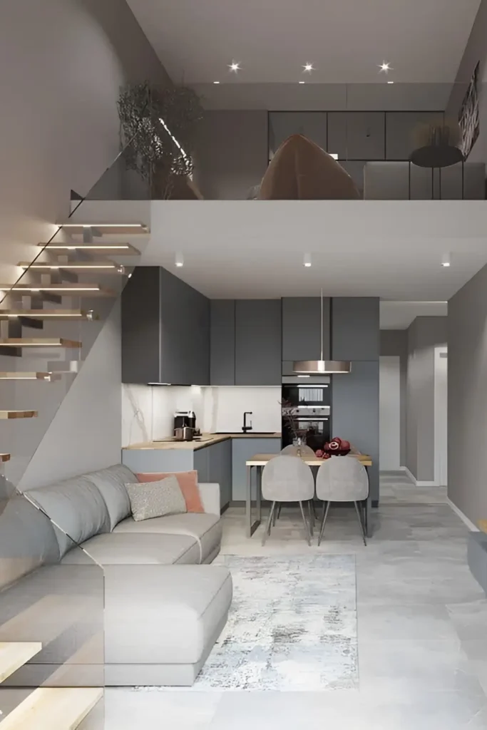 Modern grey loft with a glass staircase, muted decor, and minimalist design.