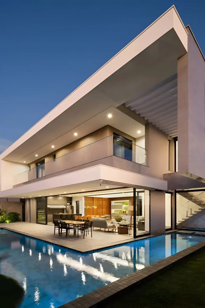 Luxury contemporary villa with minimalist design, poolside dining, sharp angles, and open-concept indoor-outdoor living.