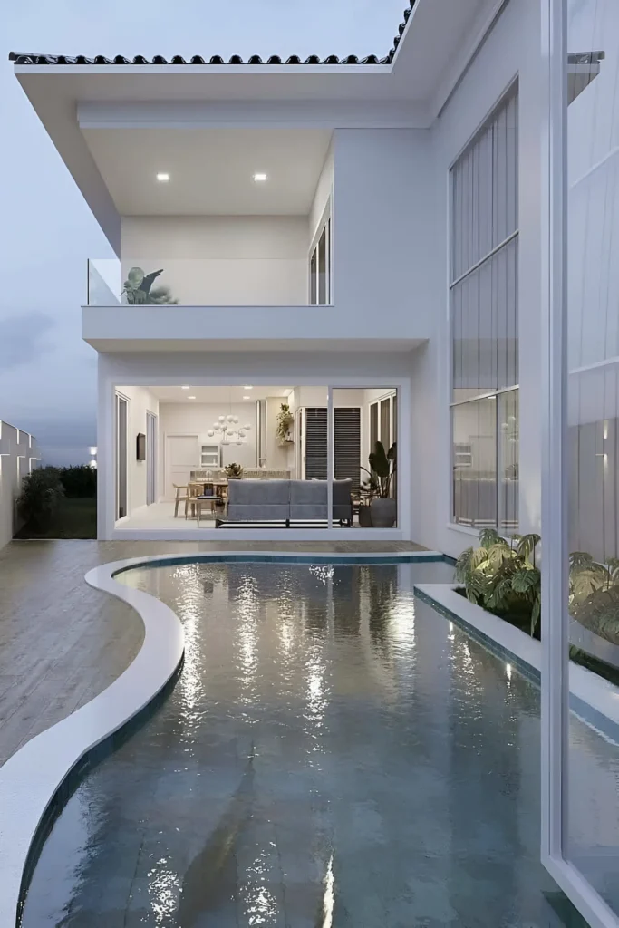 Modern home with a curved pool, floor-to-ceiling windows, and open interiors for a serene ambiance.