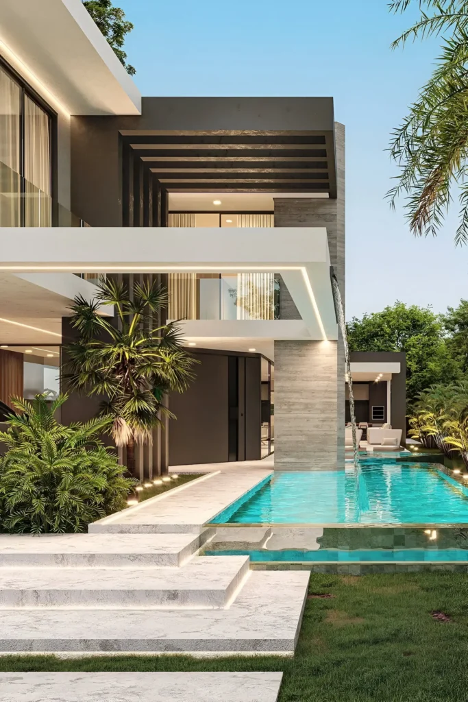 Modern poolside home with cascading water feature, integrated lighting, lush greenery, and sleek architectural design.