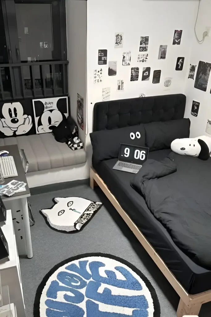 Small monochrome bedroom with black bedding, graphic wall art, tufted headboard, and playful decor.