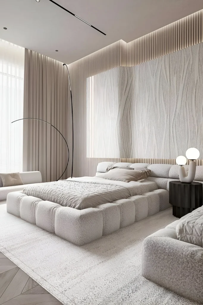 Modern bedroom featuring a plush platform bed, textured walls, neutral tones, and sleek black accents, highlighted by ambient lighting for a tranquil and elegant atmosphere.