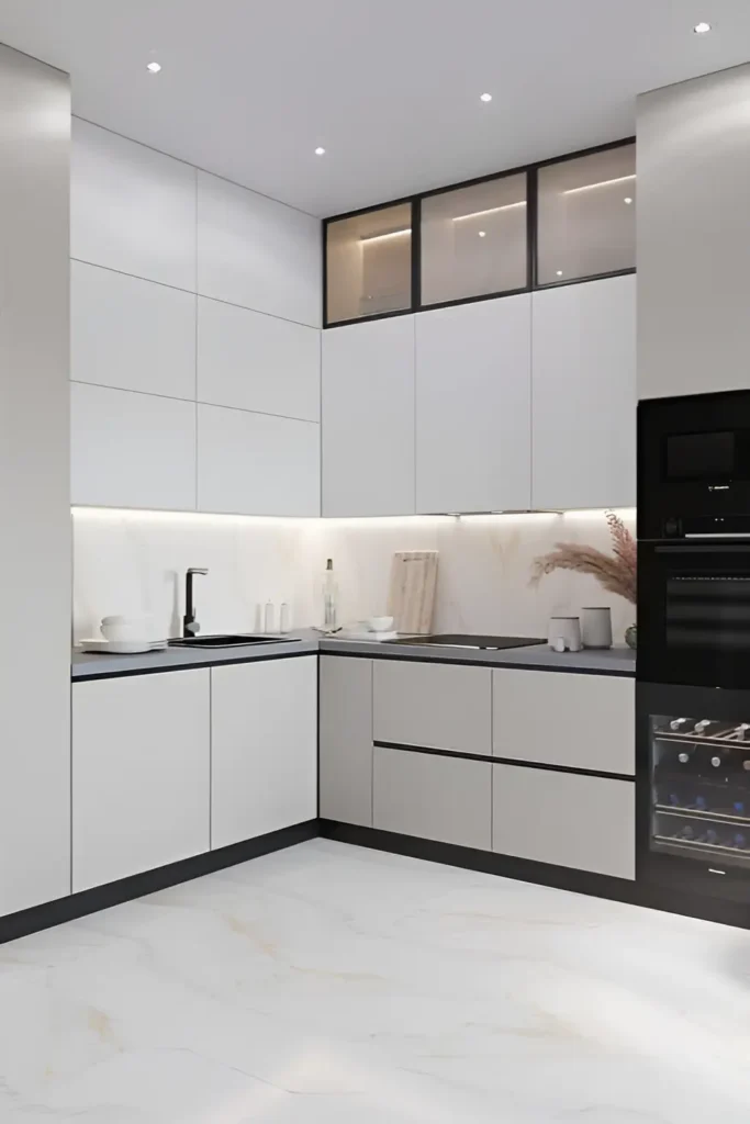 Minimalist white kitchen with black countertops, glass display cabinets, and marble-effect flooring.