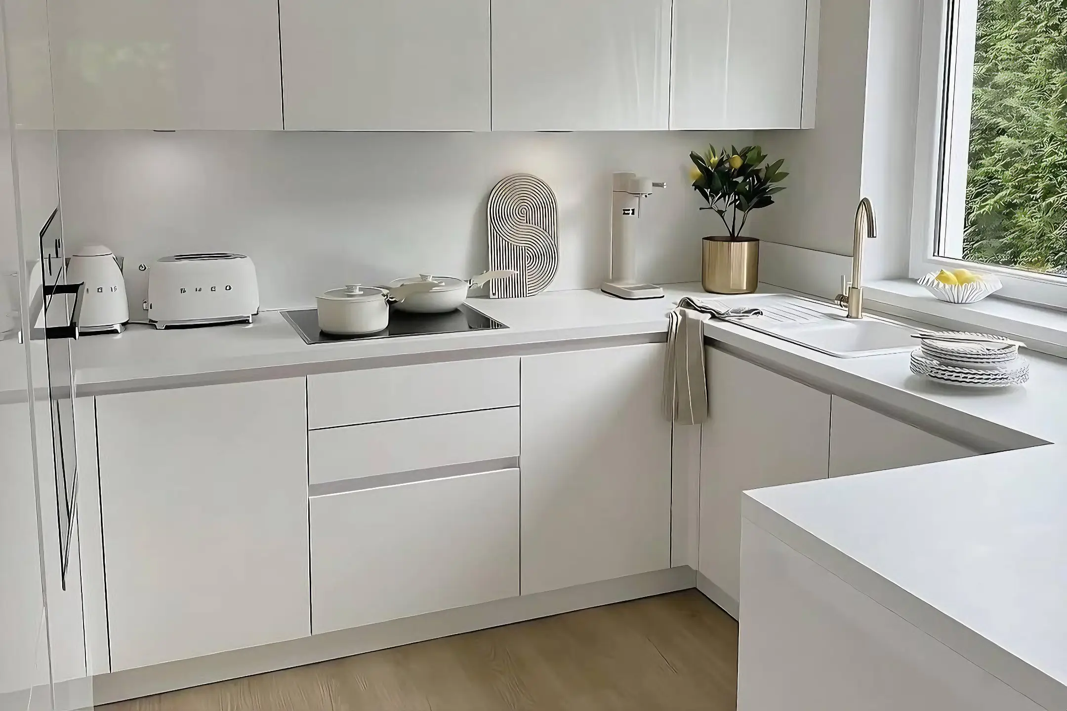 Compact minimalist white kitchen with glossy cabinetry, natural light reflections, and muted wood flooring.