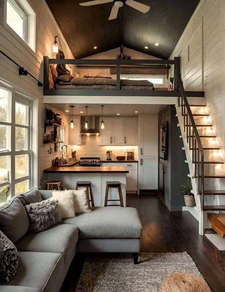 Tiny house interior with dark ceiling over loft.