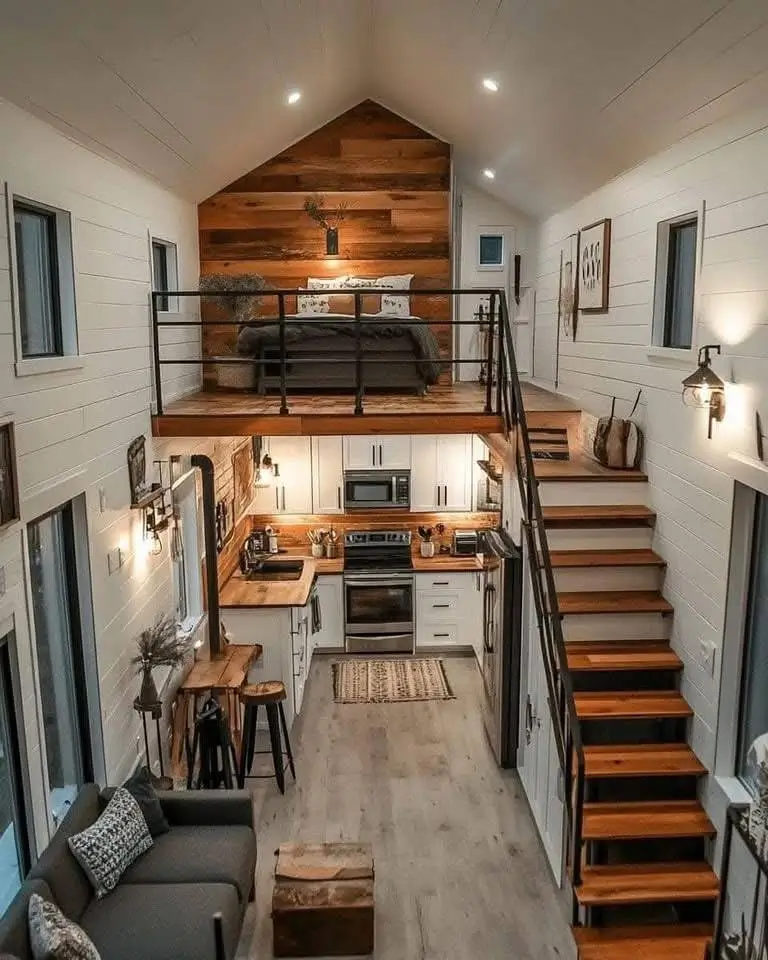 Tiny house interior with wooden feature wall in loft.