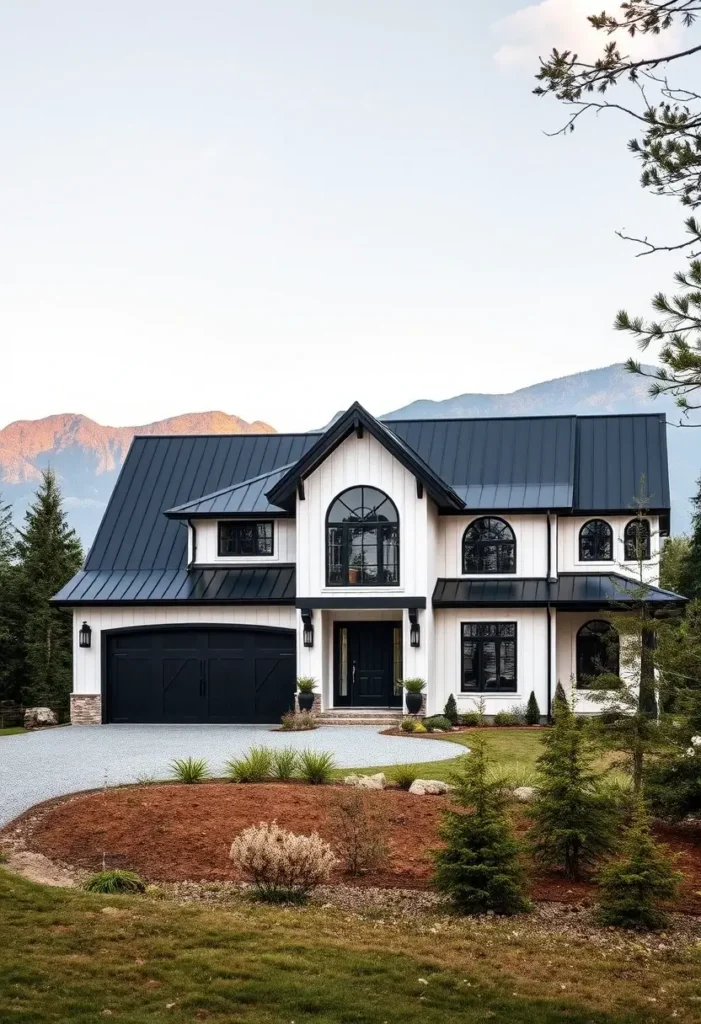 Modern black-and-white house with arched windows, bold rooflines, and a mountain backdrop surrounded by minimalist landscaping.