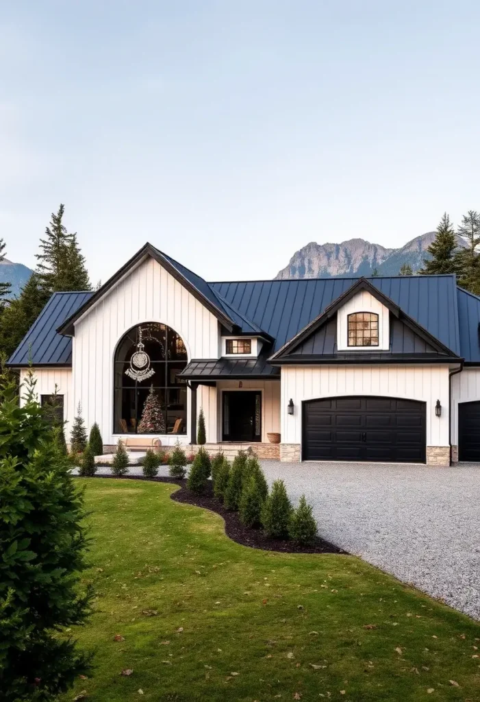 Modern black-and-white house with a large arched window, black roof, festive decor, and a mountain backdrop.