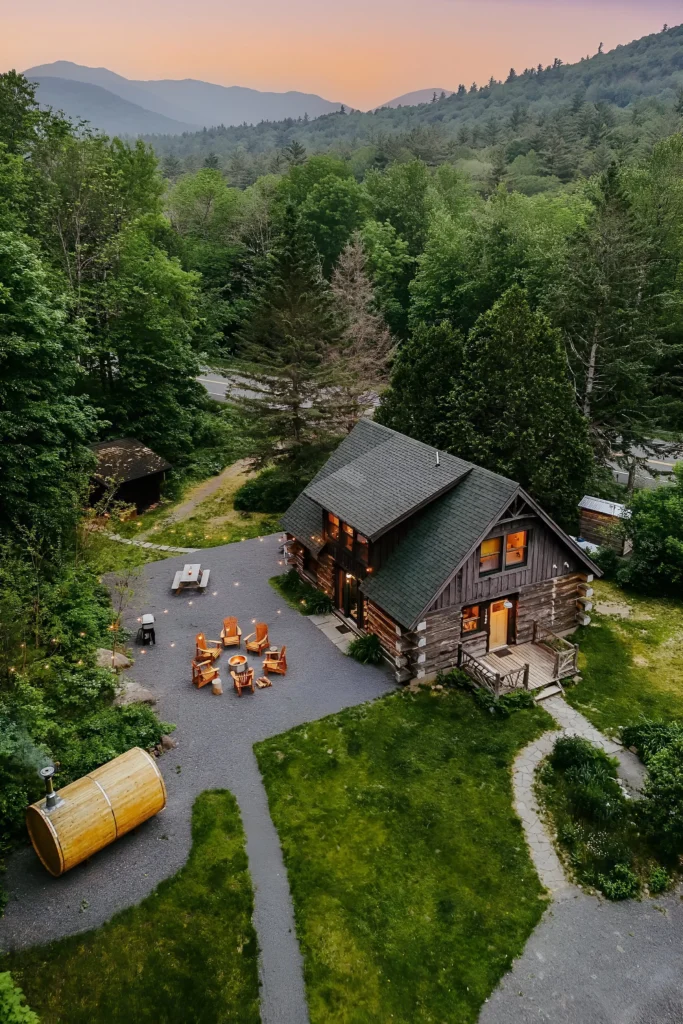 Rustic mountain cabin with an outdoor sauna, fire pit seating, and scenic mountain views.