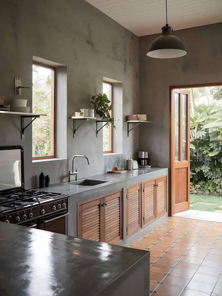 Sophisticated kitchen with dark-toned concrete countertops, walls, and wood accents.