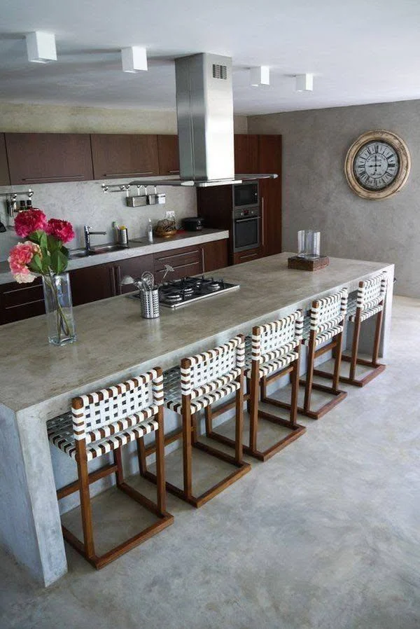 Large kitchen featuring an expansive concrete island with waterfall edges.