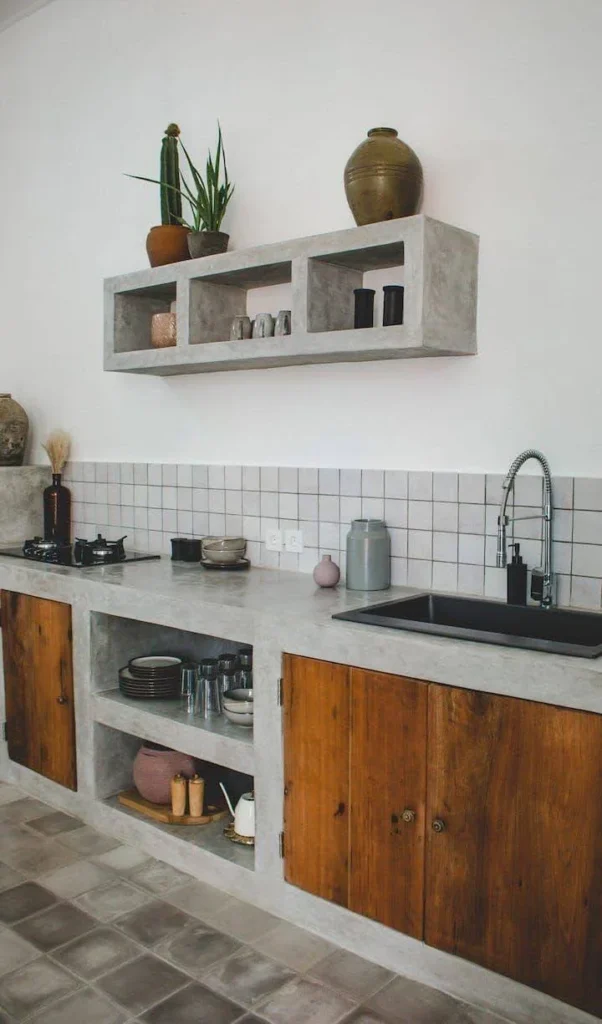 Kitchen showcasing a floating concrete shelf above a concrete countertop.