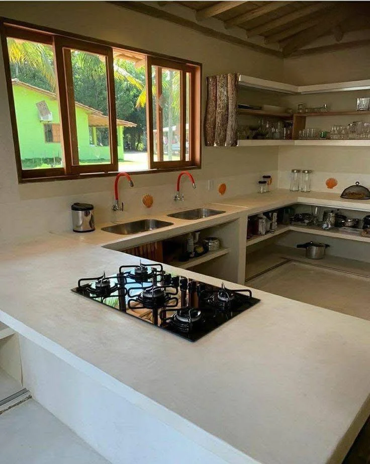 Kitchen with a long concrete countertop featuring dual integrated sinks.