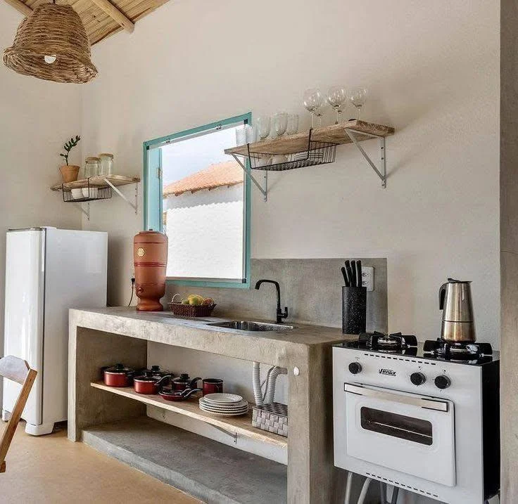 Rustic kitchen design featuring a concrete countertop and open shelving.