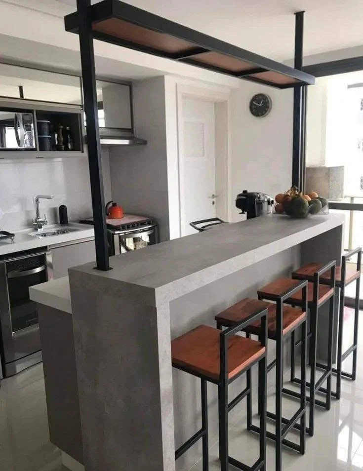 Modern concrete kitchen island with waterfall edge and seating.