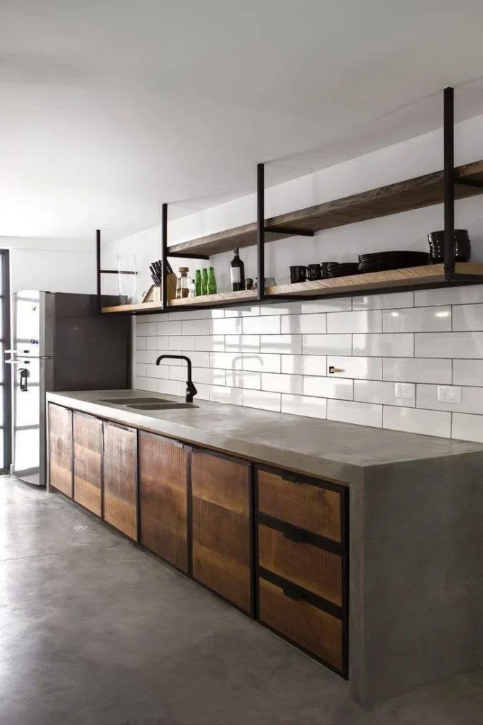 Kitchen featuring concrete countertops and a white subway tile backsplash