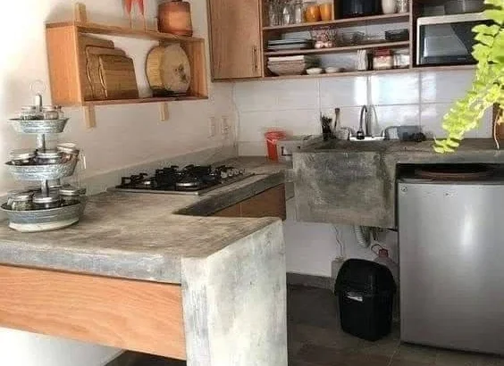 Kitchen showcasing a multi-level concrete countertop with distinct functional zones.