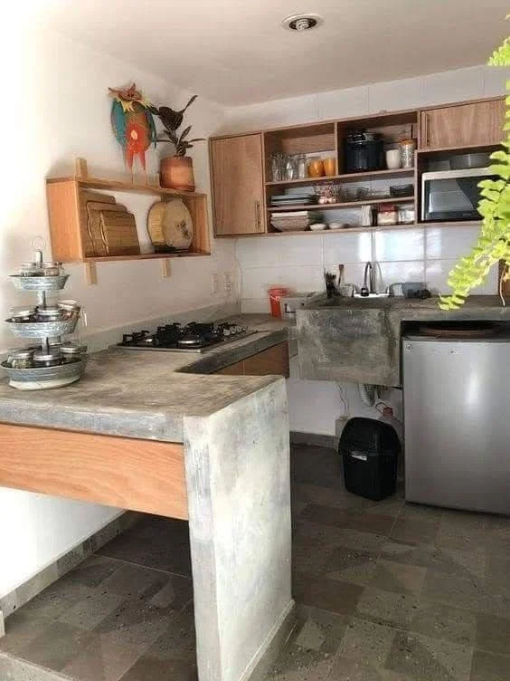 Kitchen showcasing a multi-level concrete countertop with distinct functional zones.