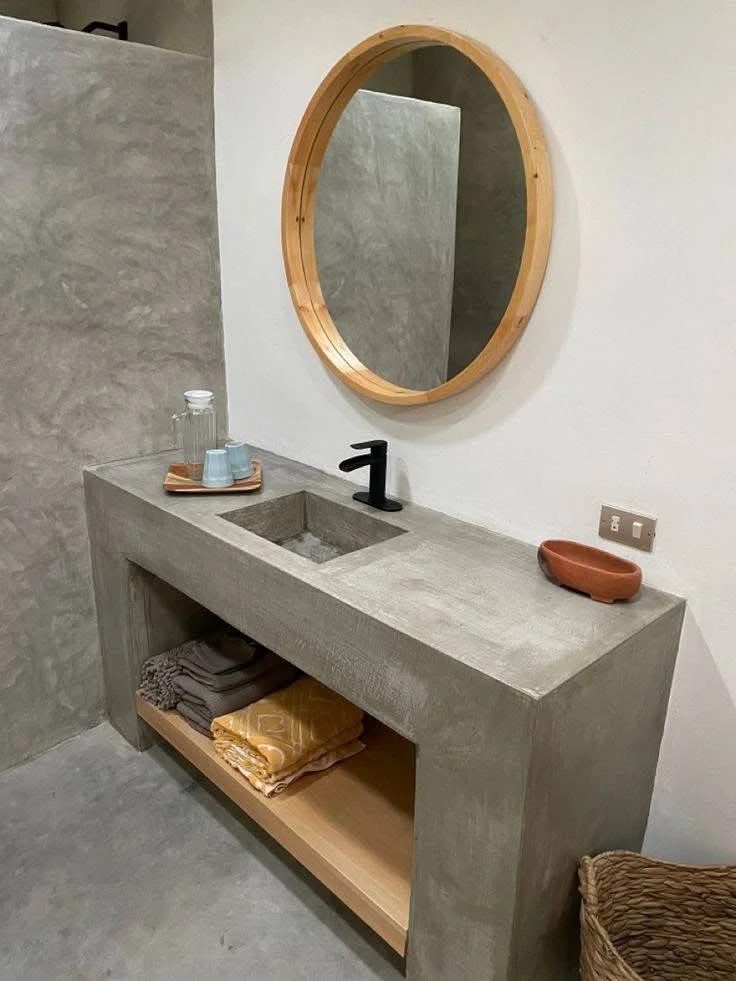 Kitchen with a concrete vanity-style countertop and integrated sink.