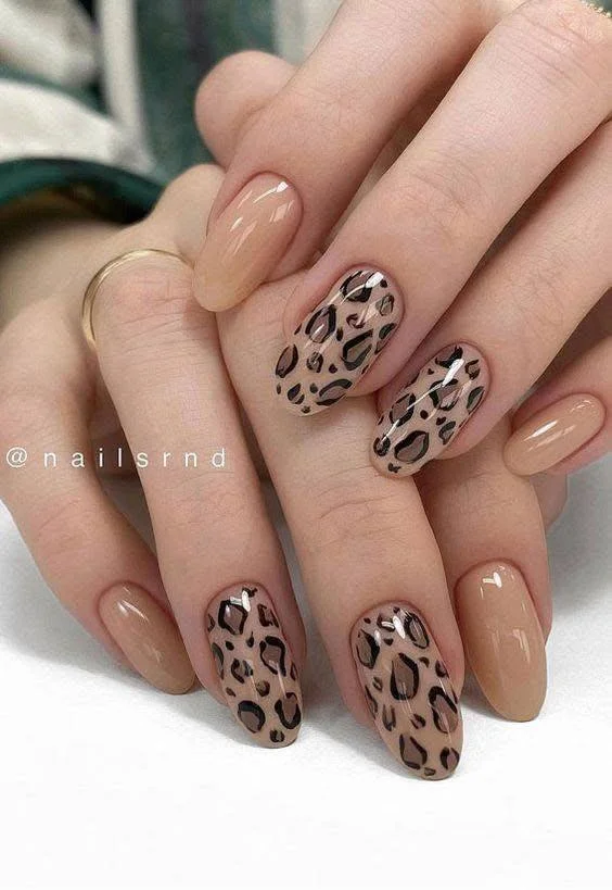 Nude nails with full leopard print on alternating nails.