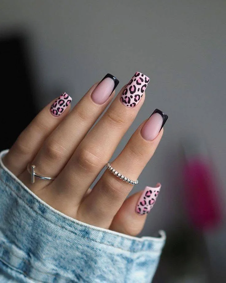 Pink and black leopard print nails with black French tips.