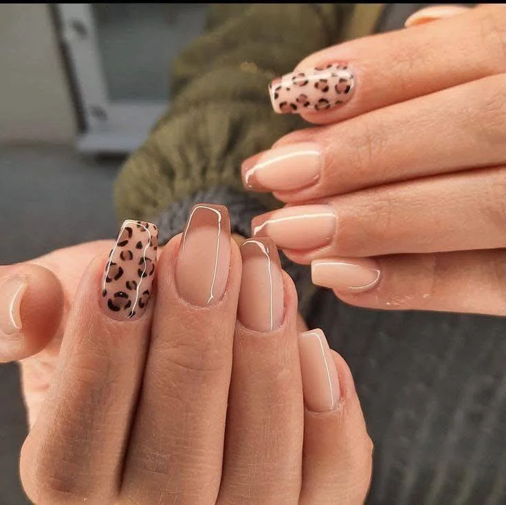 Nude nails with subtle leopard print accent nails.