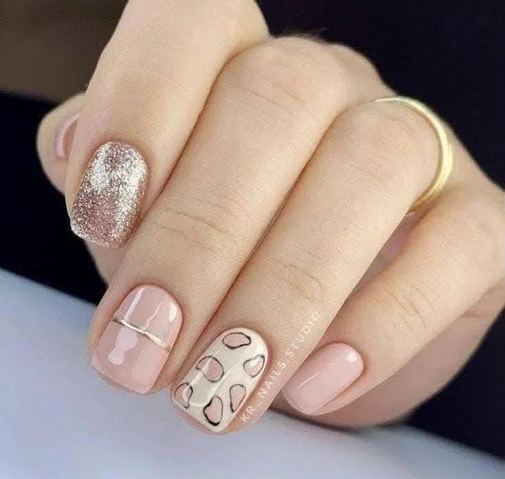 Light pink nails with minimalist leopard print outline accent.