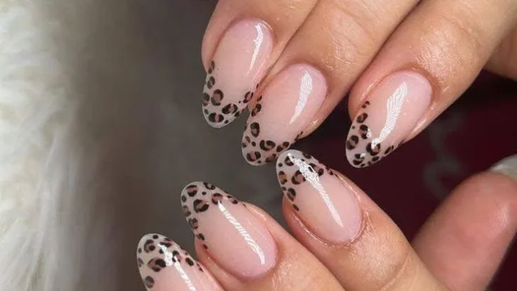 Sheer nails with leopard print French tips.