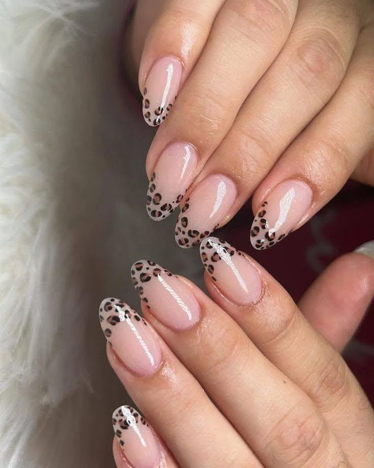 Sheer nails with leopard print French tips.