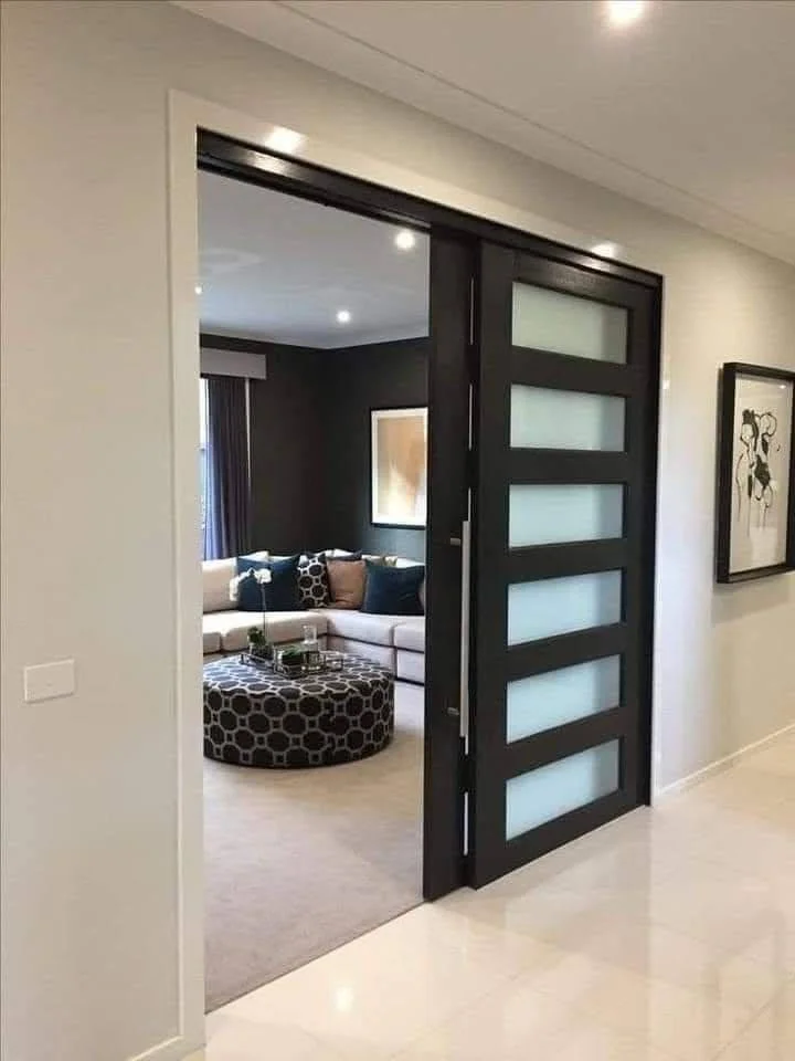 Modern sliding door with frosted glass panels between rooms.