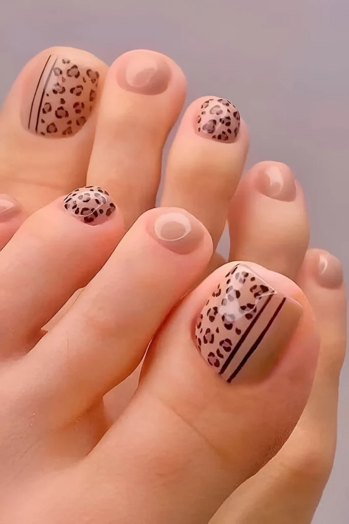 Minimalist leopard print toenail design with nude base and black line accents.