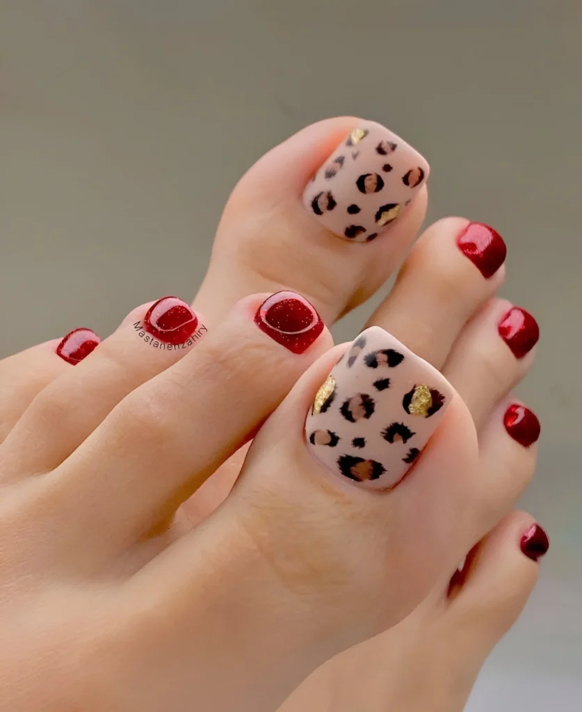 Leopard print toenails with red accents and gold details. - animal print nail designs