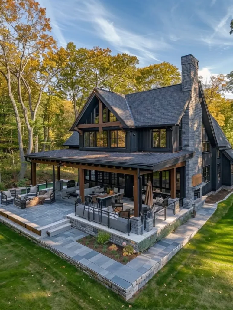 Modern farmhouse with large patio and stone chimney.