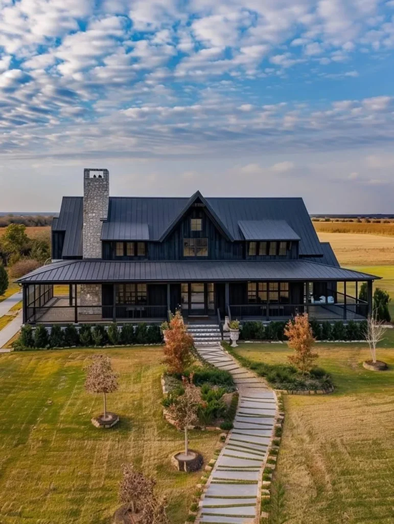 Modern black barndominium with spacious front porch.