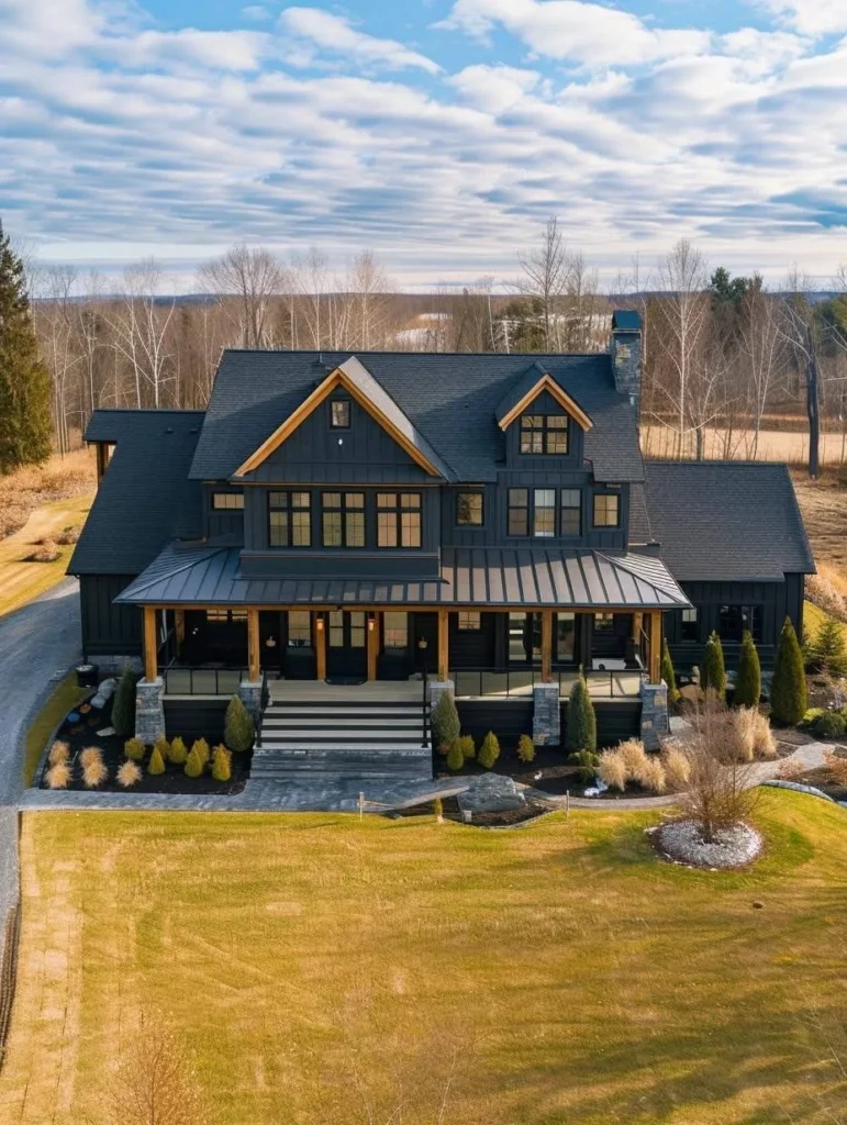 Large modern farmhouse with dark siding and symmetrical design.