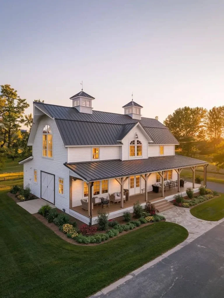 White Modern Barndominium Exterior with a dark metal roof and cupolas.