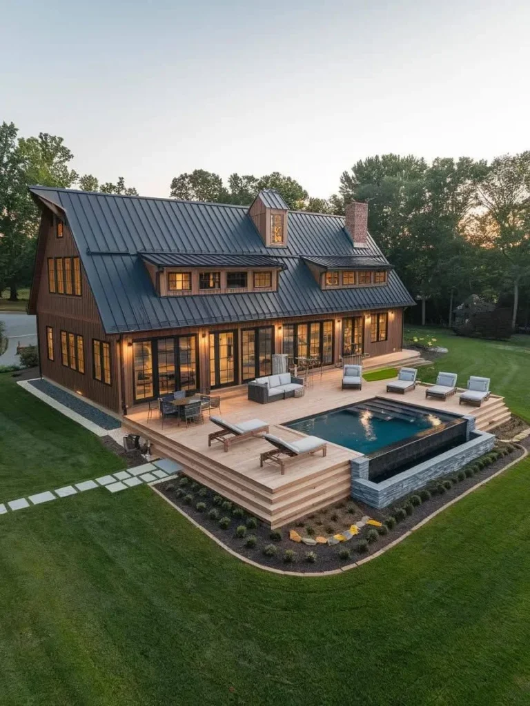 Modern Barndominium Exterior with a steeply pitched roof, wood siding, and a pool.