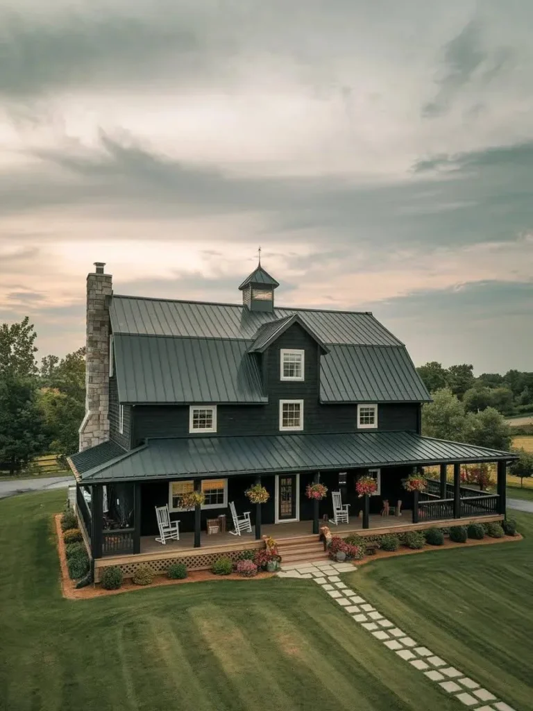 Modern Barndominium Exterior with a black metal roof, dark siding, and a wrap-around porch.