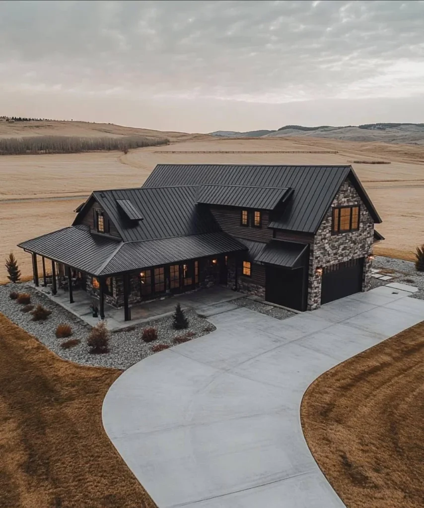 Modern Barndominium Exterior with dark siding, a metal roof, and stone accents.