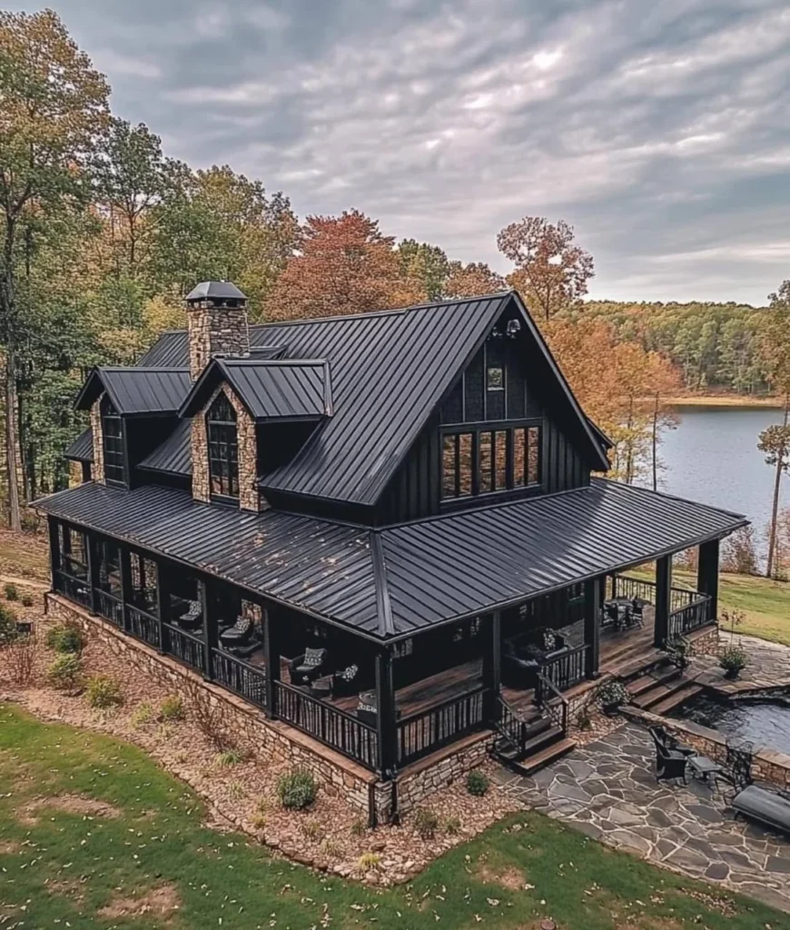 Modern Barndominium Exterior with dark siding, a metal roof, and stone accents.