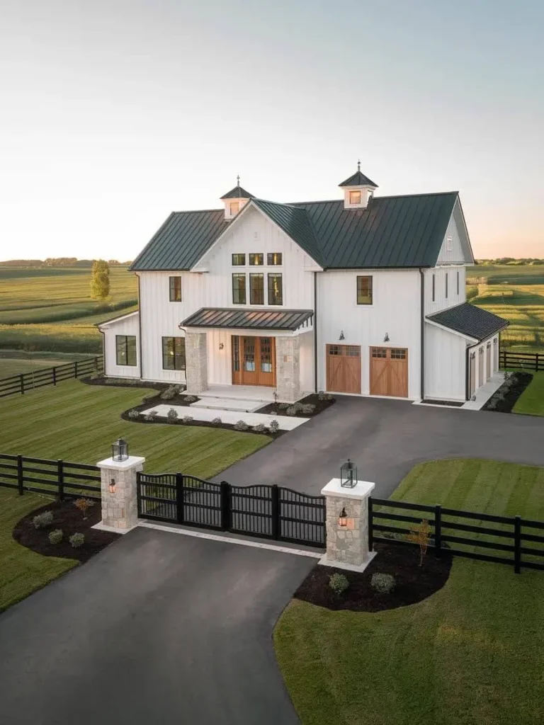 Modern Barndominium Exterior with white siding, wood garage doors, and a gated entry.