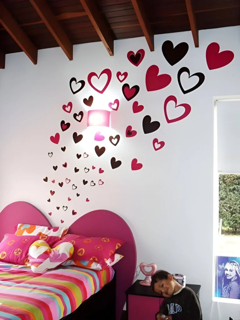 Bedroom wall with pink and black heart-shaped vinyl decals.