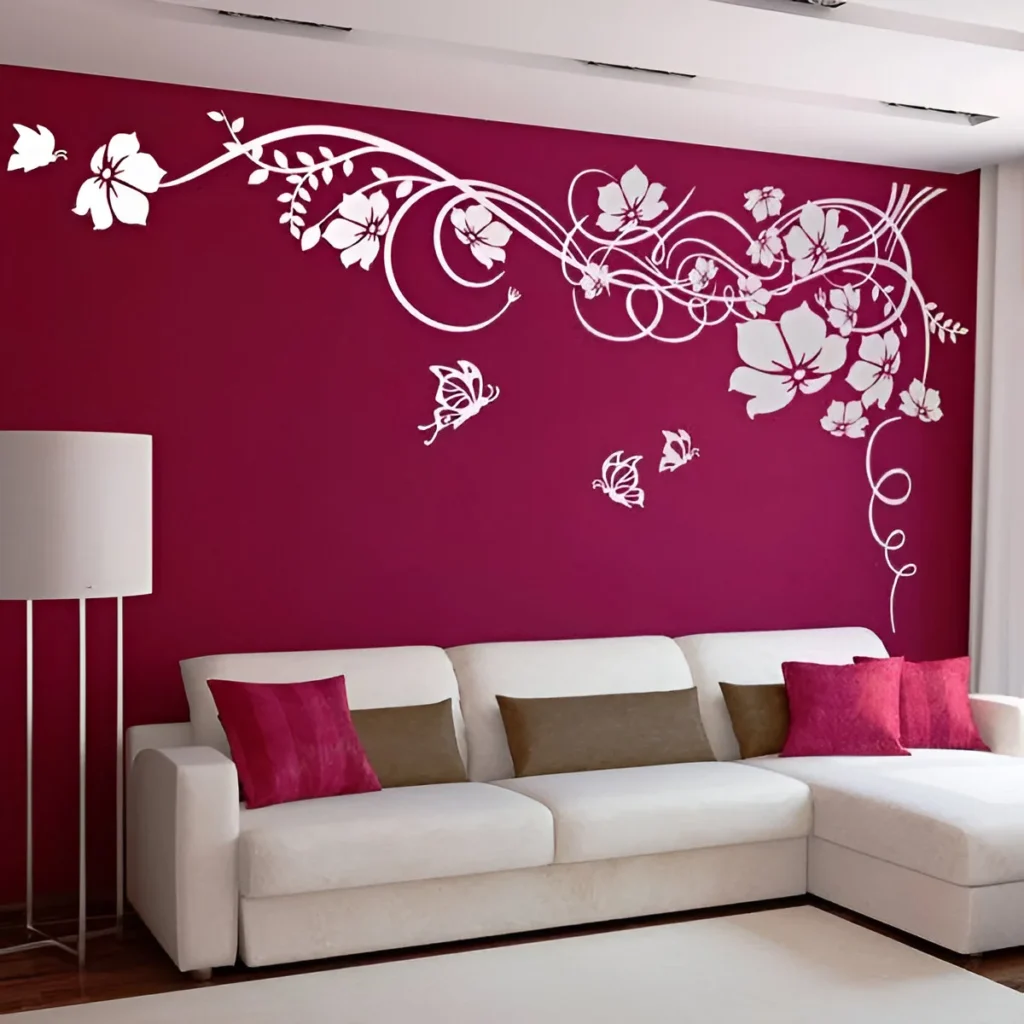 Red accent wall with white floral and butterfly decals in a bedroom.