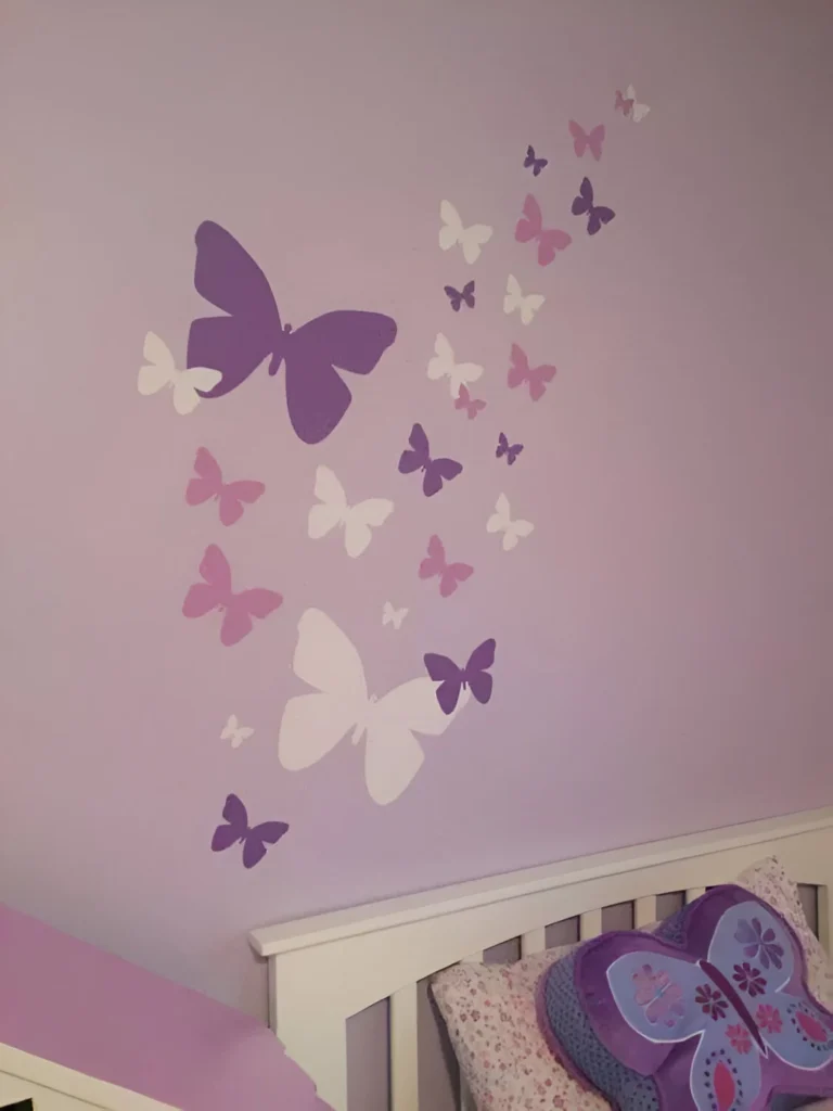 Light purple bedroom wall with various sizes and shades of purple butterfly decals.