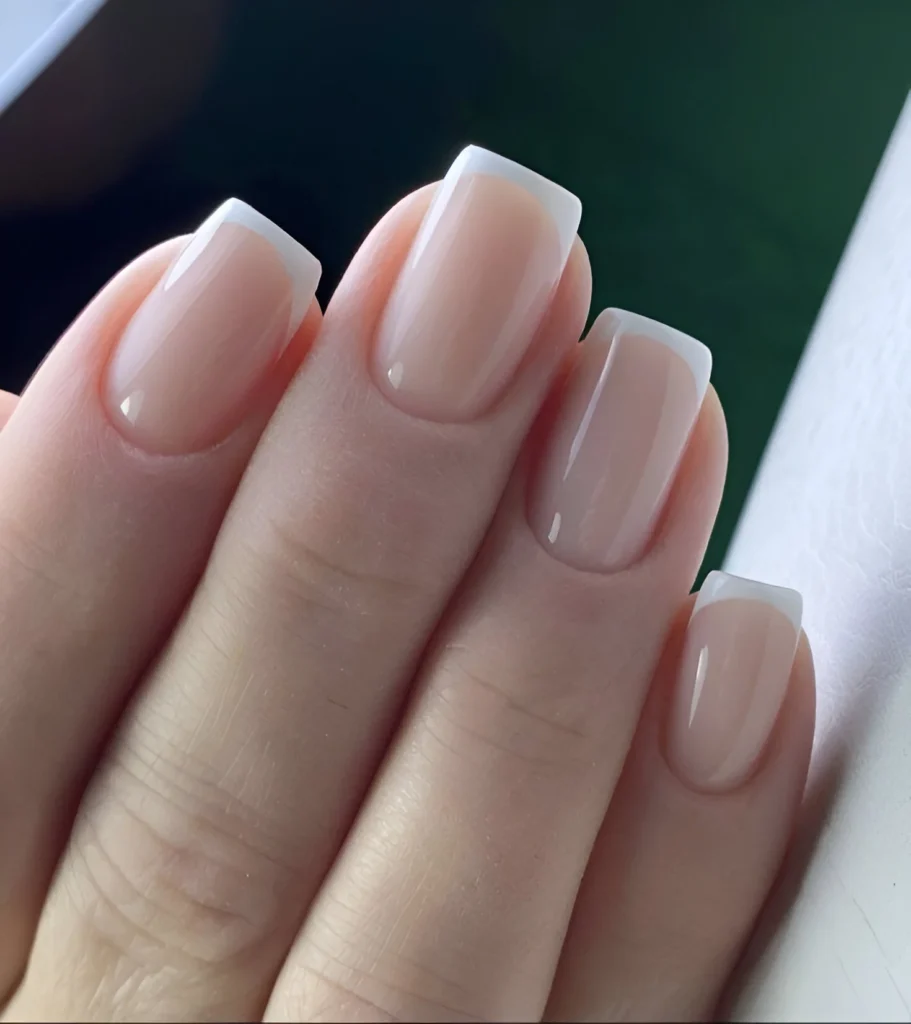 Square nails with a classic, well-executed French manicure.