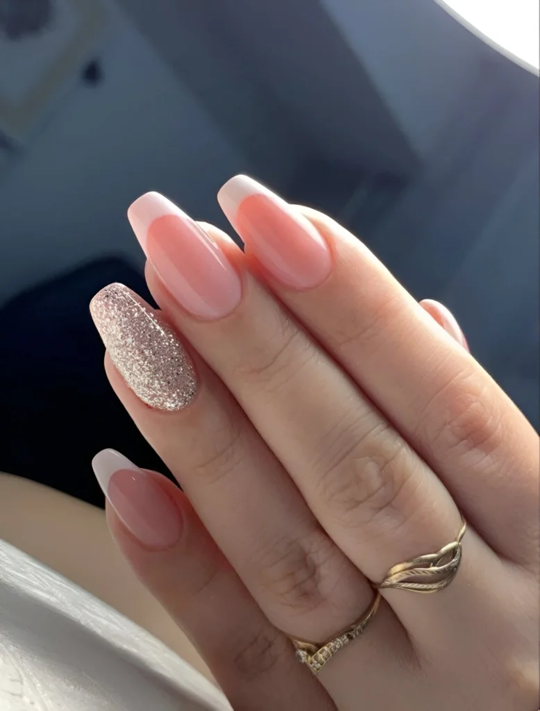 Long ballerina nails with a classic French manicure and a champagne glitter accent nail. - Classy Nails