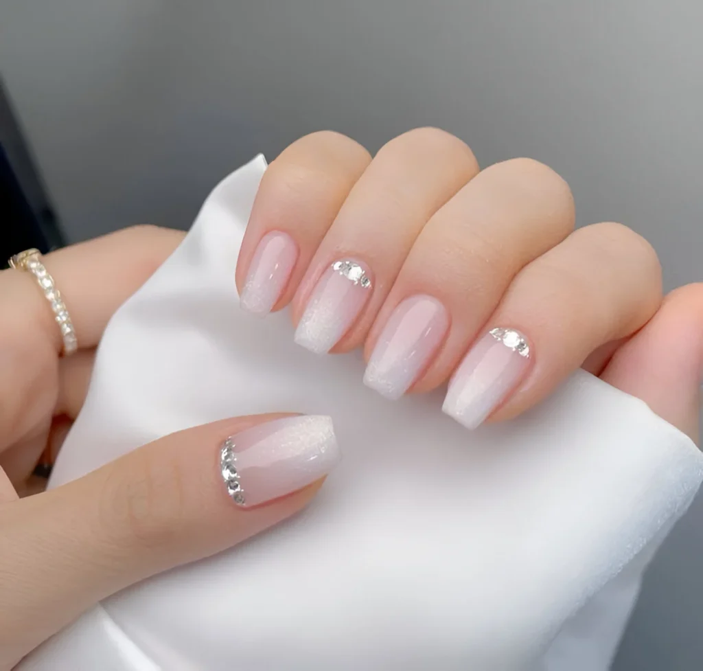 Medium coffin press-on nails with a white gradient and crystal accents.